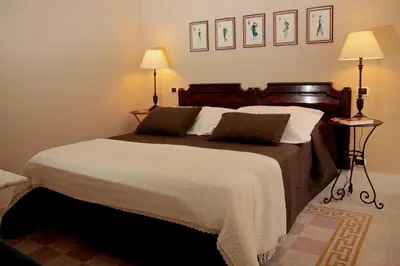 a bedroom with a large bed with two lamps at Residenza Mazzini in Rome