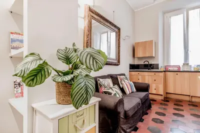 a living room with a couch and a plant at B&B Trastevere 94 in Rome