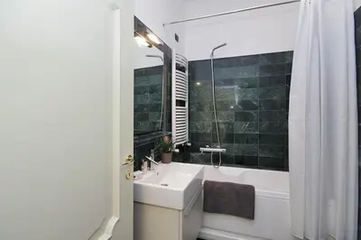 a bathroom with a sink and a tub and a shower at Crispi Luxury Apartments - My Extra Home in Rome
