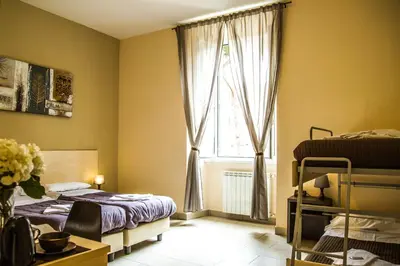 a bedroom with a bed and a window at Mosaic Central Guest House in Rome