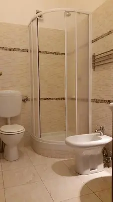 a bathroom with a shower and a toilet and a sink at Hostel Mosaic in Rome