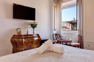 a room with a bed with a broken leg on a table at Little Rhome Suites in Rome