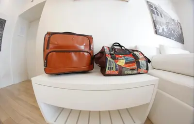 a white table with two bags on top of it at Tullia&Prisca Relais in Rome