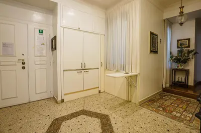 a hallway with a white door and a table at Casa Riz in Rome