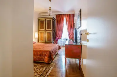 a bedroom with a bed and a dresser and a window at Casa Riz in Rome