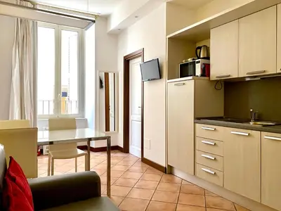 a kitchen with a table and a dining room at SWEETSUITE Rome in Rome