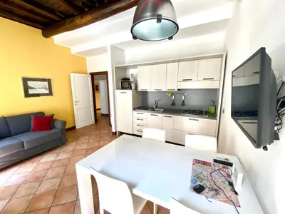 a kitchen and living room with a white table at SWEETSUITE Rome in Rome
