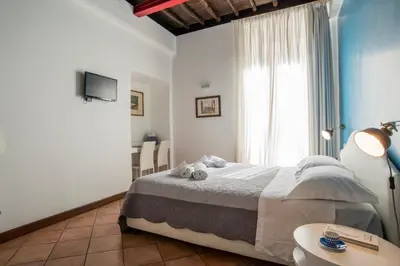 a bedroom with a bed and a large window at SWEETSUITE Rome in Rome