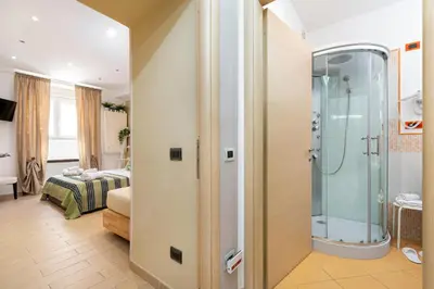 a bathroom with a shower and a bedroom at Next Stop St Peter Rome in Rome