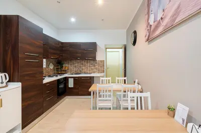 a kitchen and dining room with a table and chairs at Next Stop St Peter Rome in Rome