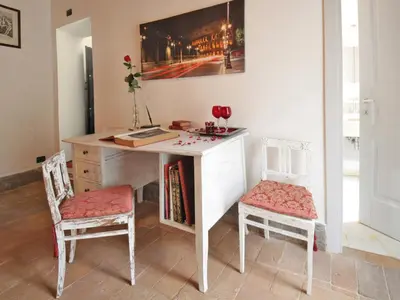 a desk with two chairs and a table with books at Nostromondo Apartments in Rome City Centre in Rome