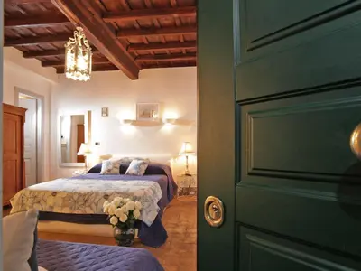 a bedroom with a bed and a green door at Nostromondo Apartments in Rome City Centre in Rome