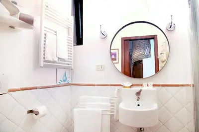 a bathroom with a sink and a mirror at Nostromondo Apartments in Rome City Centre in Rome