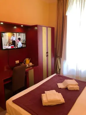 a hotel room with a bed with two towels on it at Quality in Rome in Rome