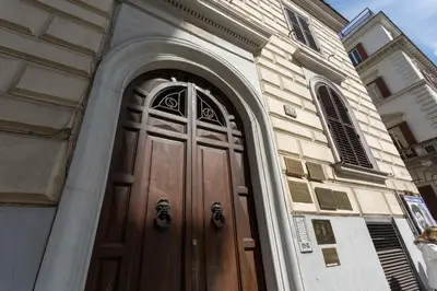 a church with a wooden door on a building at Quality in Rome in Rome