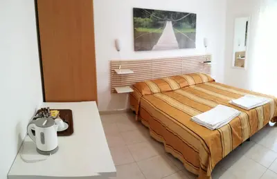 a bedroom with a bed and a table in it at Testa Gioacchino B&B in Rome