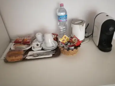 a table with a coffee maker and a bottle of water at Testa Gioacchino B&B in Rome