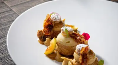 a plate of food with ice cream on a table at DOM Hotel Roma - Preferred Hotels & Resorts in Rome