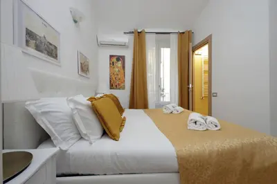 a white bedroom with a bed with towels on it at Dream City Rome in Rome