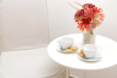 a table with two cups and a vase with flowers at Dream City Rome in Rome