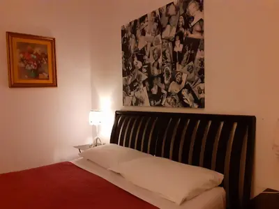 a bedroom with a bed and a picture on the wall at St. John Villa in Rome