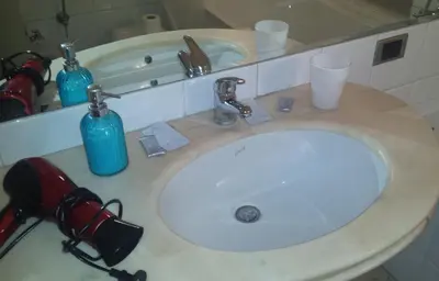 a bathroom counter with a sink and a mirror at St. John Villa in Rome