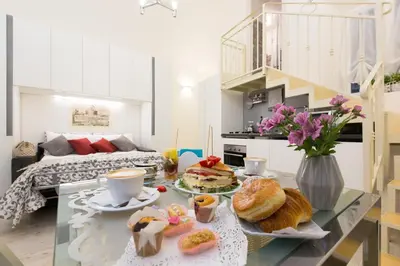 a room with a table with breakfast foods on it at Navona Open Space Apartments in Rome