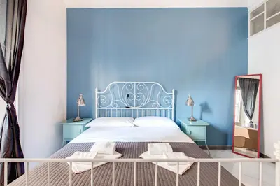 a blue bedroom with a bed with a blue wall at Locanderia Roma in Rome