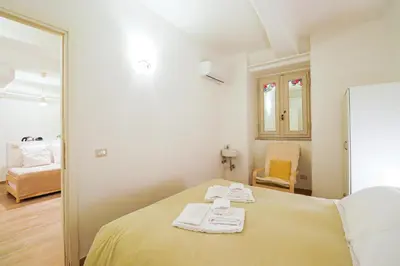 a bedroom with a bed with two towels on it at Locanderia Roma in Rome
