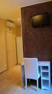 a room with a desk and a tv on a wall at B&B In Piazza in Rome