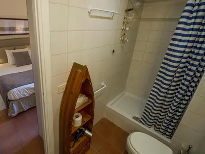 a bathroom with a shower and a toilet and a bed at Bed & Breakfast A Casa di Lia a Roma in Rome