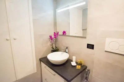 a bathroom with a sink and a mirror at Erida Apartment Spanish Steps in Rome