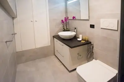 a bathroom with a white sink and a toilet at Erida Apartment Spanish Steps in Rome