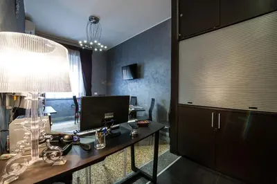 a room with a desk with a lamp and a mirror at Domus Fabiola - Vaticano in Rome