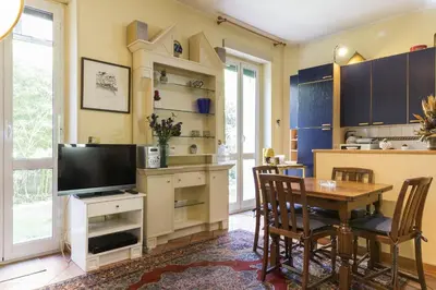 a kitchen and dining room with a table and a television at Lemon Tree Apartment Sistine Chapel in Rome