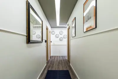 a hallway with white walls and a blue rug at Fleming Suites by Hili in Rome