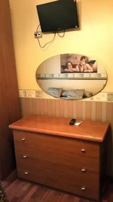 a mirror above a dresser with two people in it at Petite Maison in Rome