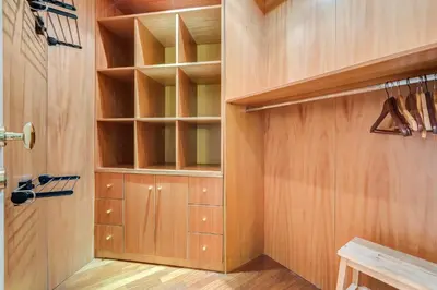 a walk in closet with wooden walls and shelves at Luxury House Belle Arti Rome City Center in Rome