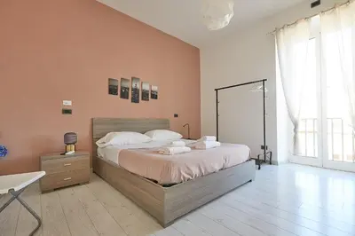 a bedroom with a large bed and a large window at Apartment in front of St Peter's Square and Vatican Museums - myPad in Rome in Rome