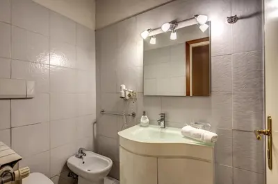 a bathroom with a sink and a toilet and a mirror at Moro Magenta 1 Casa e Appartamento per Vacanze in Rome