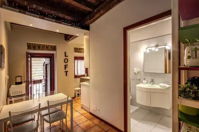 a kitchen and dining room with a table and a sink at Moro Magenta 1 Casa e Appartamento per Vacanze in Rome