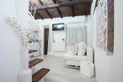 a living room with a white couch and a table at Moro Magenta 1 Casa e Appartamento per Vacanze in Rome