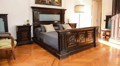 a bedroom with a large wooden bed in a room at B&B Villa Musa in Rome
