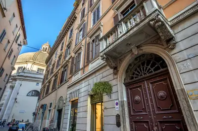 a building with a brown door on a street at Casavignoni elegant 3BR home near to Spanish step in Rome