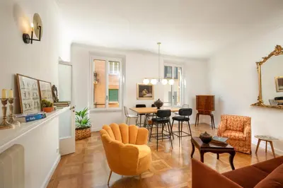 a living room with a table and chairs at Casavignoni elegant 3BR home near to Spanish step in Rome
