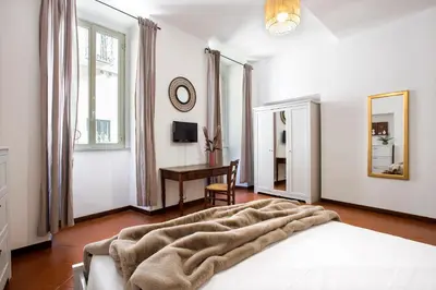 a white bedroom with a bed and a desk at Trevi Fountain House Deluxe in Rome