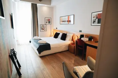 a hotel room with a bed and a desk and a desk at DownTown Boutique House - CA Domus Collection in Rome