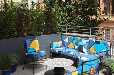 a patio with two chairs and a table at W Rome in Rome