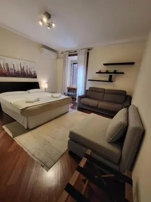a large bedroom with a bed and a couch at Colosseo Homerents 2 in Rome
