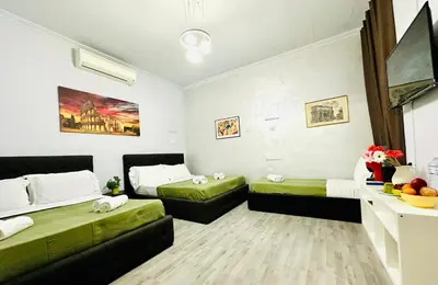 a small room with two beds and a couch at Termini luxury home in Rome